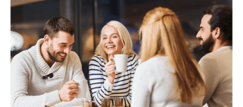 group of people laughing drinking coffee